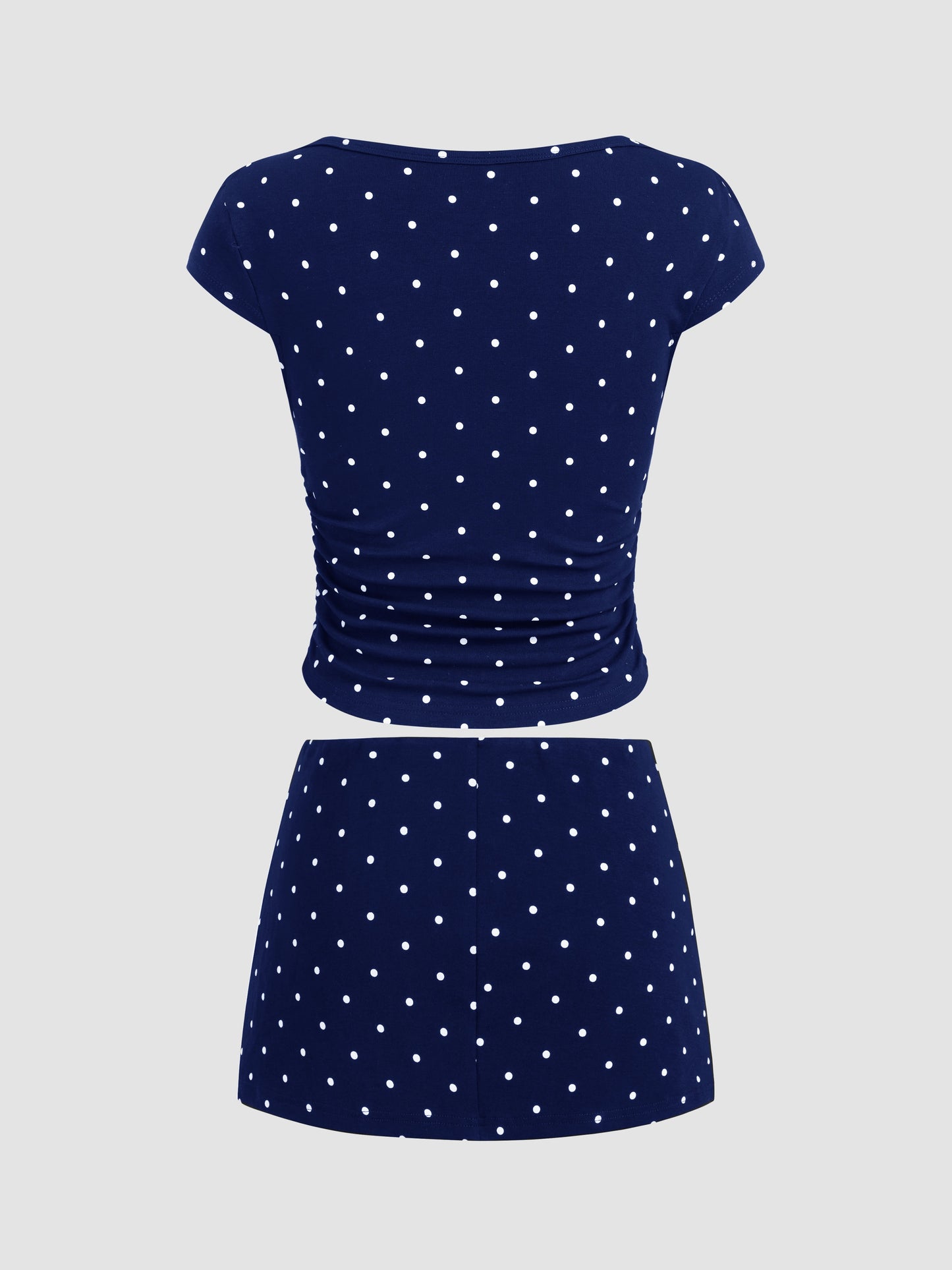 Mia - Camiseta acanalada de lunares con cuello barco y minifalda con short interior